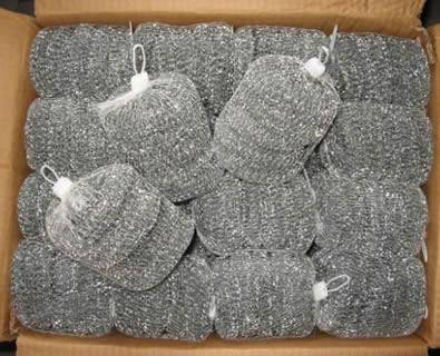 Bags of galvanized steel scrubbers are put into a carton case.